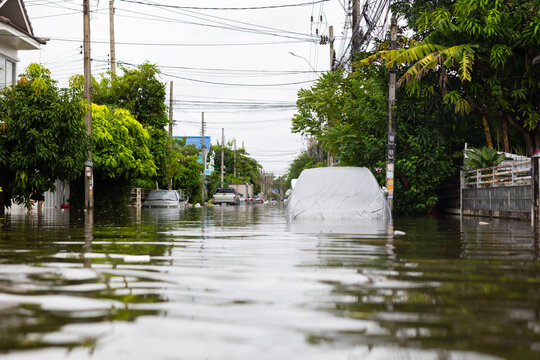 Cars submerged in water. Street after heavy rain. Disaster Motor Vehicle Insurance Claim, Severe weather