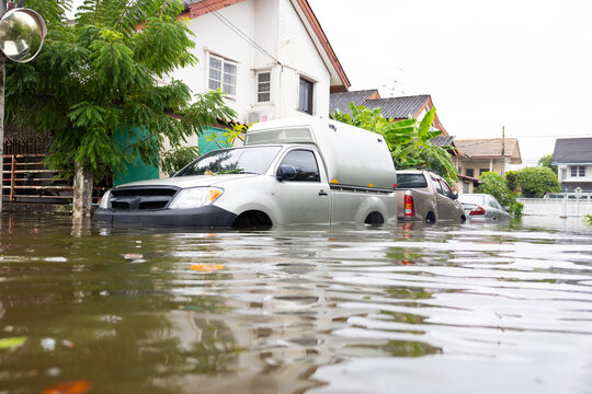 Cars submerged in water. Street after heavy rain. Disaster Motor Vehicle Insurance Claim, Severe weather