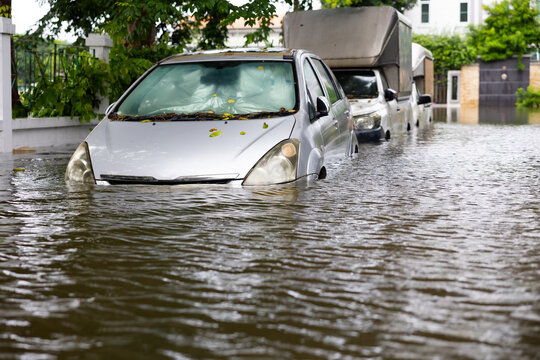 Cars submerged in water. Street after heavy rain. Disaster Motor Vehicle Insurance Claim, Severe weather