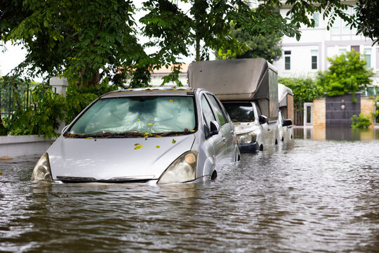 Cars submerged in water. Street after heavy rain. Disaster Motor Vehicle Insurance Claim, Severe weather