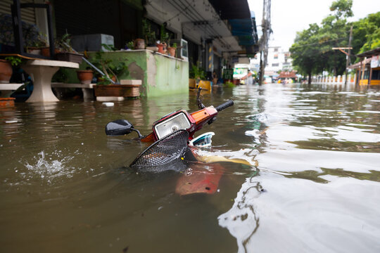 motorcycle is submerged in water flooded . Street after heavy rain. Disaster Motor Vehicle Insurance Claim, Severe weather