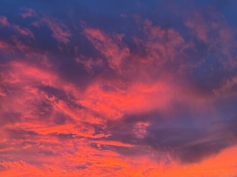 Outstandingly surreal sunset in NY just after a September Nor'easter storm.  Fluorescent magenta red and purple blue clouds took over gray sky for just a few minutes as the sun went down below horizon