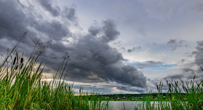 Dense clouds loom over calm waters