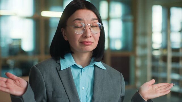 Portrait doubtful Asian business woman thinking shrug shoulders spreading hands unsure reaction looking at camera Korean female Chinese businesswoman Japanese architect think showing uncertain gesture