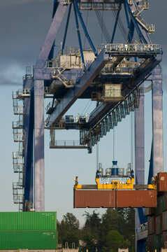 Canada, BC, Surrey.  Surrey Fraser Docks.  Container crane at work on the Surrey Fraser docks.