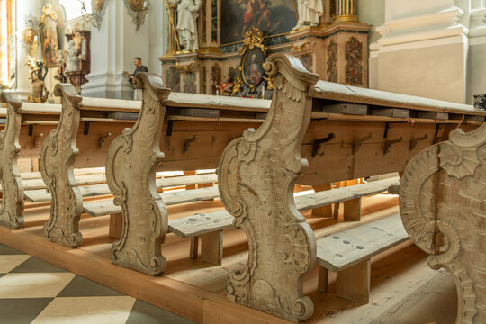 Toblach (Dobbiaco), Italy. Ornately carved wooden church pews in a Baroque parish church