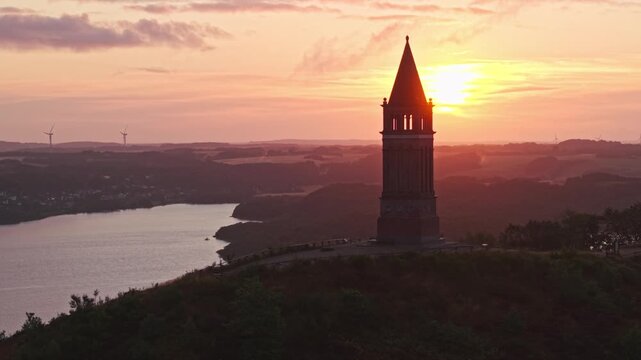 Aerial view of Himmelbjerget tower at sunset overlooking the lake and surrounding landscape in Skanderborg Municipality, Skanderborg Municipal, Denmark.