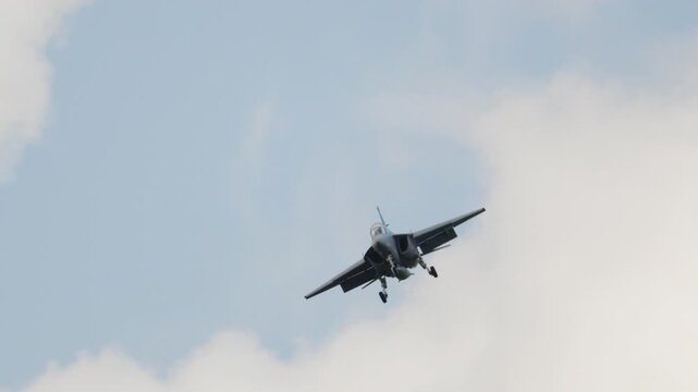 Military FA 50 jet fighter landing gear down flying