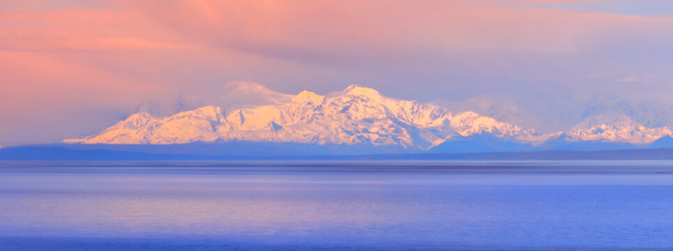 Alaska Anchorage seascape at Cook Inlet at low tide with view of Mt. Susitna and cloudscape at sunrise in USA.