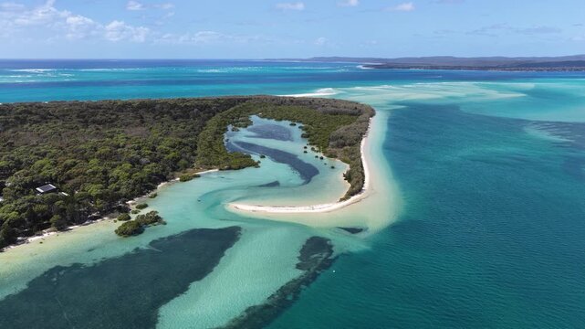 Aerial view of the turquoise waters and sand banks of Day's Gutter on Moreton Island, surrounded by lush mangroves and coastal vegetation in Kooringal, Queensland, Australia.