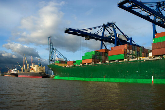 Canada, BC, Surrey, Vancouver.  Container ship at dock on the lower Fraser River between New Westminster and the Georgia Strait.  Surrey Fraser Docks
