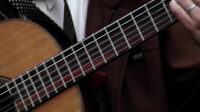 Musician Plucking Strings on Acoustic Guitar with Capo Outdoors - 4K