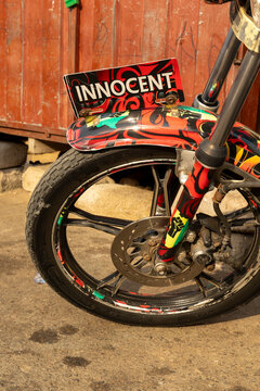 Decorated motorcycle wheel with Innocent sign, Cape Coast, Ghana