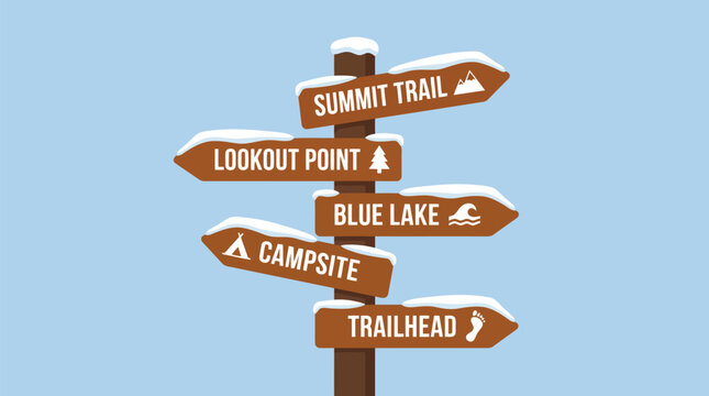 Winter wooden signpost with snowy directional arrows for hiking