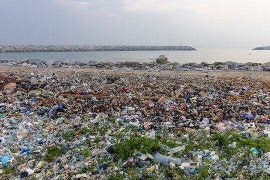 Plastic waste covering beach near breakwater, Cape Coast, Ghana