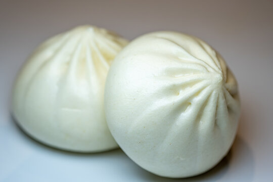 Close-up view of fresh steamed white Chinese baozi buns.