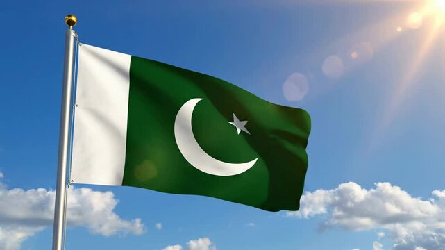 Pakistani flag waving proudly in the wind against a bright blue sky with sun flares and fluffy white clouds