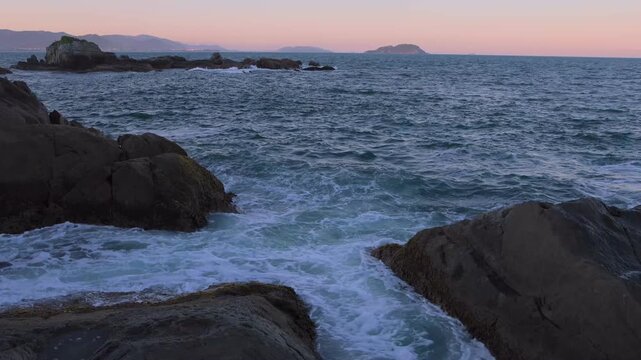Florianopolis-SC-Brazil-Golden sunset over the ocean with powerful waves breaking against coastal rocks
Seascape at sunset with sea waves crashing on rocky shore under a golden sky
Dramatic ocean