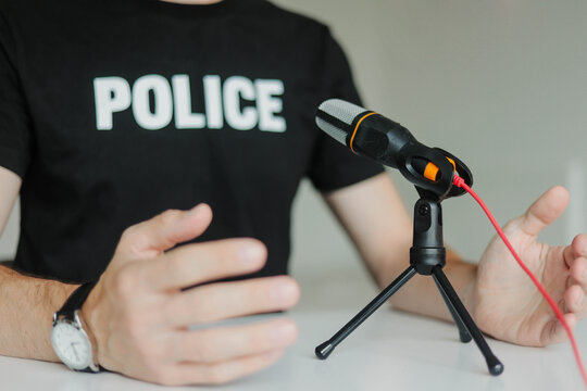 Police officer giving an official press conference. Law enforcement representative speaking into a microphone, delivering a statement or public briefing.
