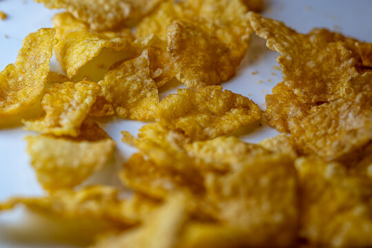 Macro shot of crunchy golden cornflakes breakfast cereal.