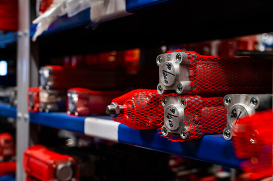 Industrial warehouse shelves with mechanical parts and cylinders