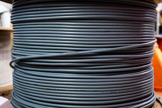 Industrial spool of gray cable in warehouse