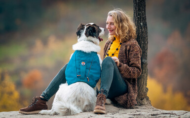 Obraz premium happy woman with dogs playing outdoors in autumn forest