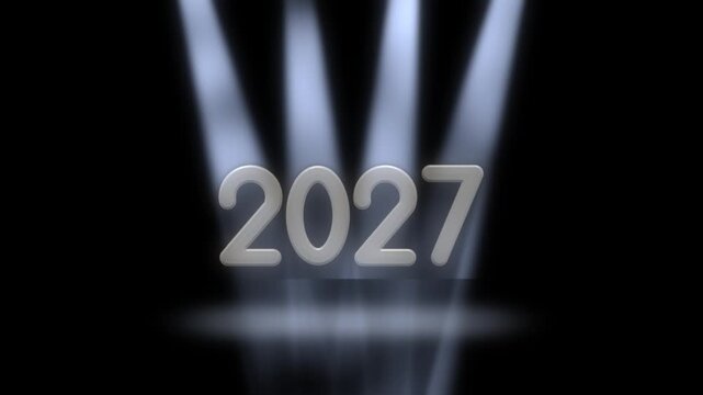 New Year 2027 on stage as four spotlights switch on one by one, each bluish white beam revealing a silver digit from left to right above a glowing pool of light before fading into black
