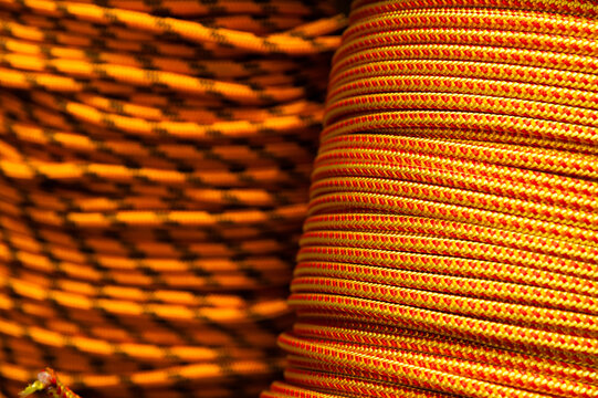 Close-up of coiled orange and red climbing ropes