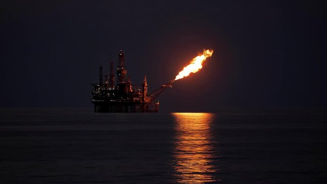 Offshore Platform Flaring Gas Above Dark Water at Night