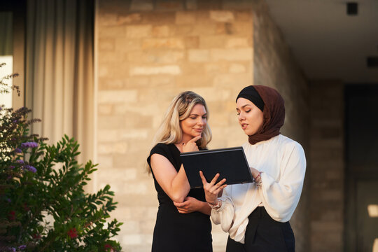 Business Colleagues Consulting Tablet Together Outside Office &mdash; Diverse Professional Women in Conversation