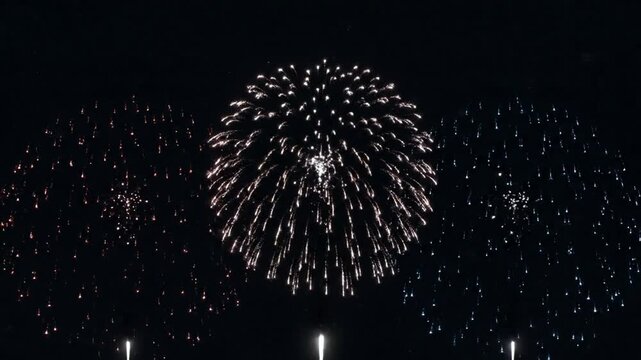 Patriotic red, white, and blue fireworks exploding in night sky: 4th of july celebration and national holiday loop