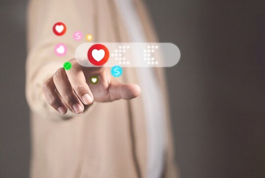 Social media engagement concept with hand touching digital heart icon, virtual interface for marketing and online business.
