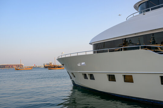 Doha, Qatar - November 8, 2024: A spectacular fusion of past and present at the Qatar Boat Show, where cutting-edge modern yacht designs anchor against Doha's iconic skyline and rich seafaring legacy.
