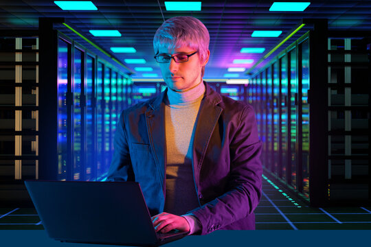 Data center operations, IT specialist works on a laptop between server racks, managing cloud computing, network infrastructure and digital systems.