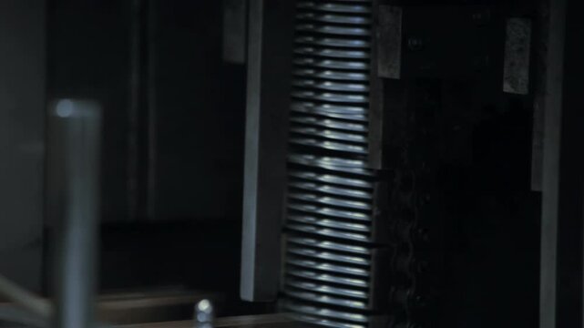 Stacks metal can lids food factory. Closeup canning machine pan dark workshop.