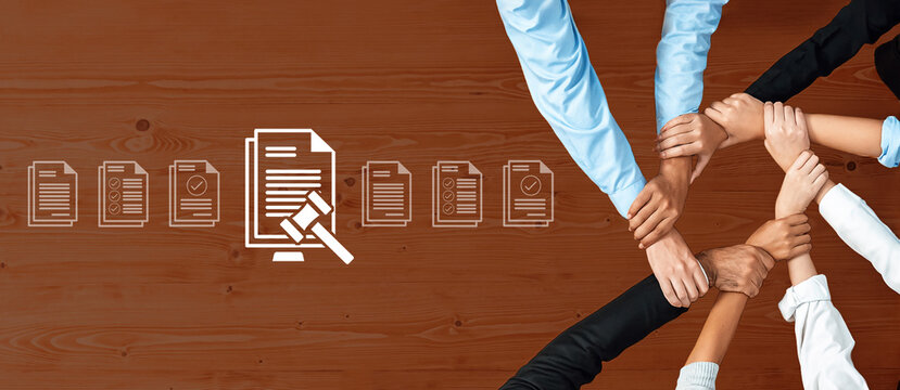 A dynamic representation of teamwork in a professional setting, showcasing diverse hands uniting around legal documents and agreements to symbolize collaboration and unity in the workplace. Ledger