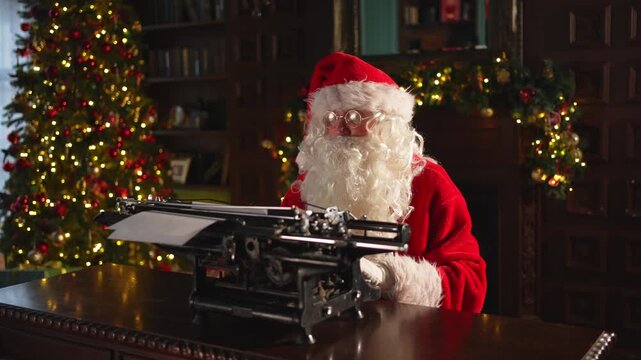 Merry Christmas. Santa mail. Happy Santa typing tact on typewriter for New Year Christmas in festive living room. Santa typing letter on Christmas eve. Mail of Santa Claus. Winter Holiday Celebrations