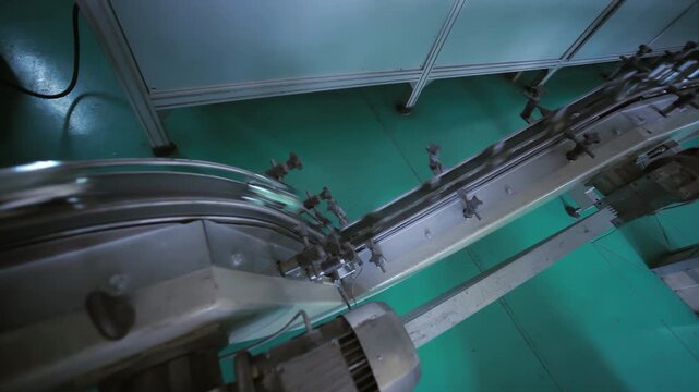 Steel conveyor belt line running food factory. Handheld industrial machinery.