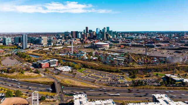 Aerial view of the Denver skyline featuring the amusement park, highway traffic, and urban landscape in Denver, Colorado, United States.