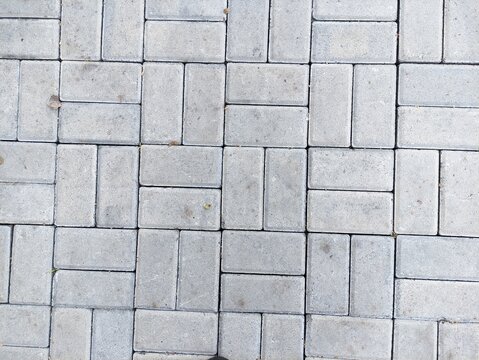 Top view of gray paving block stone texture background for outdoor footpath pavement sidewalk road construction pattern