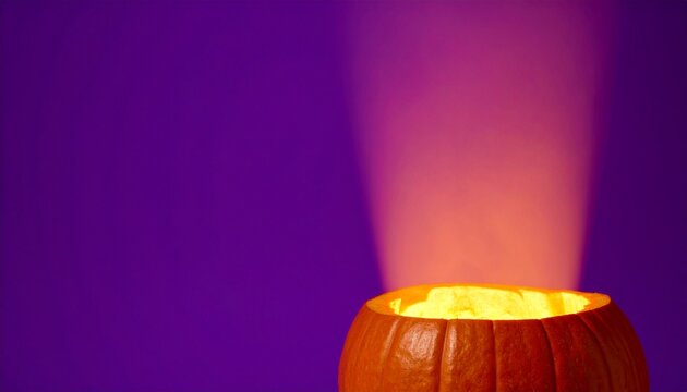 Glowing Halloween Pumpkin Product Display with Purple Background, Orange Light and Copy Space