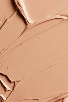 Foundation swatches creating textured cosmetic background for beauty, makeup, and skincare concepts