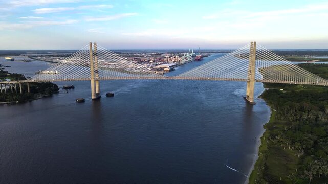 Cable-stayed bridge spans a river near Jacksonville port facilities in 4K video
