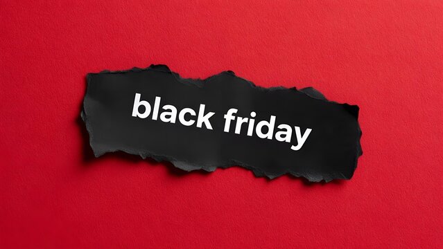Black friday text printed on black ripped paper banner positioned horizontally over a vibrant crimson red textured background showcasing dramatic shadows and highlights