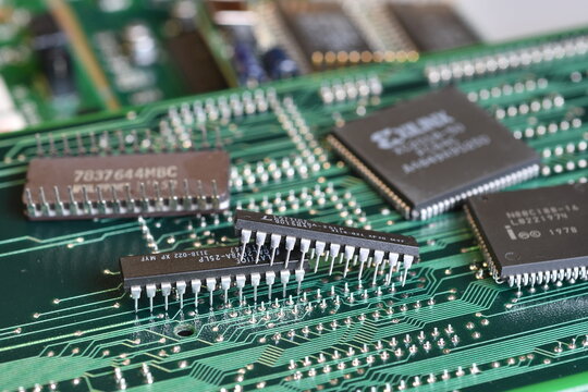 Florence, Italy - 23th december 2025: Vintage green computer motherboard with retro semiconductor components, microprocessors and microchips