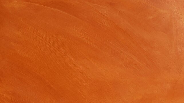 Close-up of an orange-colored surface. the surface appears to be smooth and glossy, with a rough texture. the color is a warm, earthy orange with a subtle sheen.