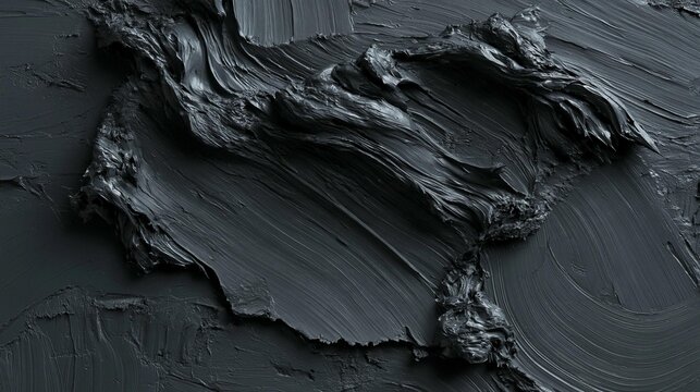 Close-up of a textured surface with a dark grey color. the texture appears to be rough and uneven, with some areas of the surface appearing to be jagged and uneven.