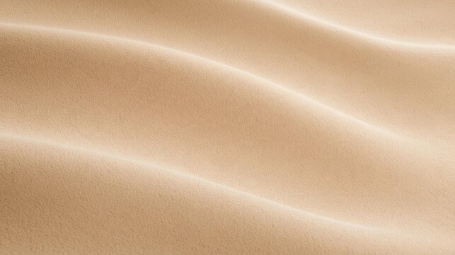 Close-up of a beige-colored fabric with a smooth and smooth texture. the fabric appears to be made of a soft, silky material and has a subtle sheen to it.