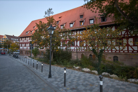 Historic half-timbered building with a red tiled roof along a quiet street in Nuremberg Germany